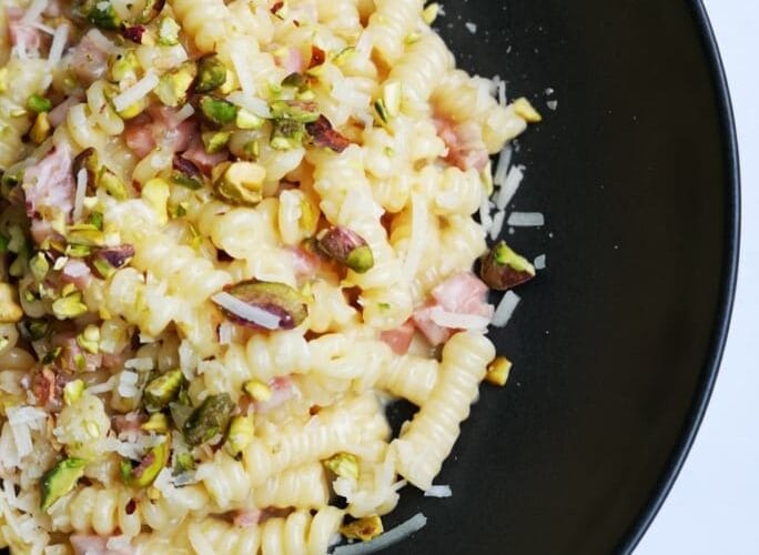 Fusilli Corti Bucati with Grana Padano fondue, mortadella and pistachio crumbs