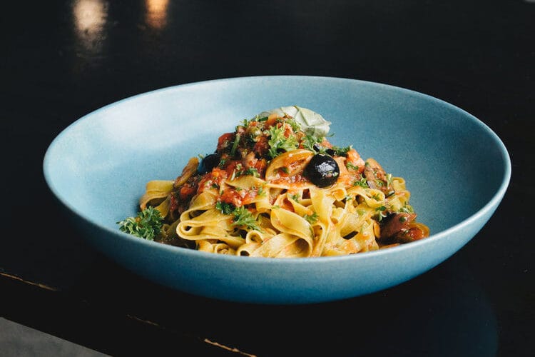 EGG & SPINACH TAGLIATELLE with garlic, parsley, tomato, anchovies, marinated olives, capers